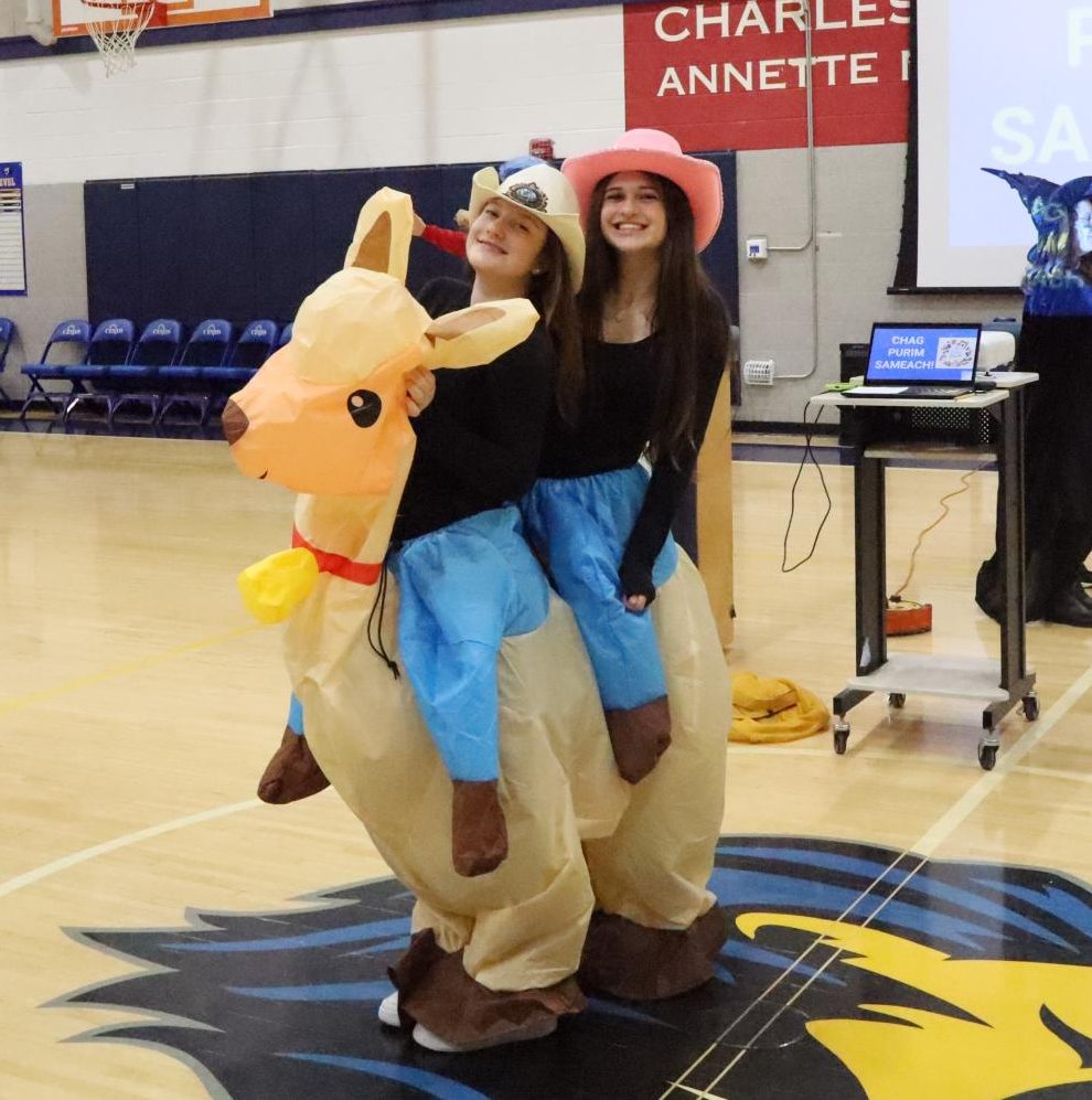 Juniors Emunah Simkovich and Brielle Bassin wear an inflatable llama costume fit for two.