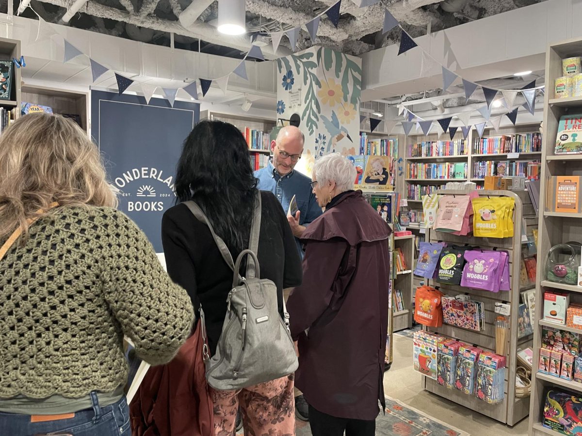 Author Michael Lowenthal signs copies of his newest book, "Place Envy," at Wonderland Books.