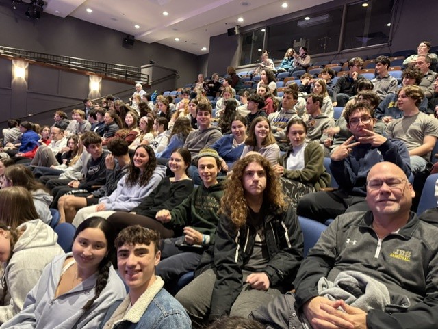 Sophomores, juniors and teachers pose for a photo before a performance of "Eureka Day" at Theater J.