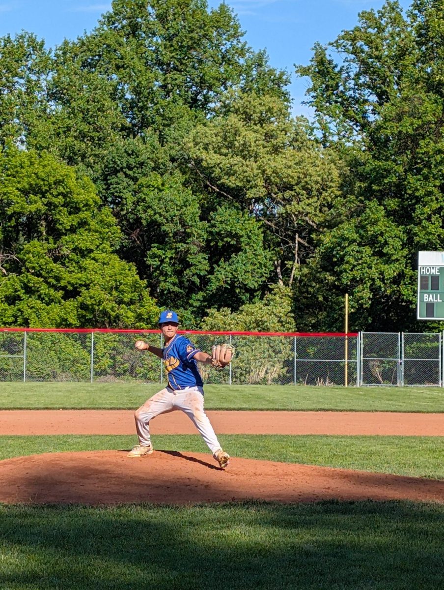 Freshman Mason Salomon winds up for a pitch while facing a Mustang batter on junior night. 