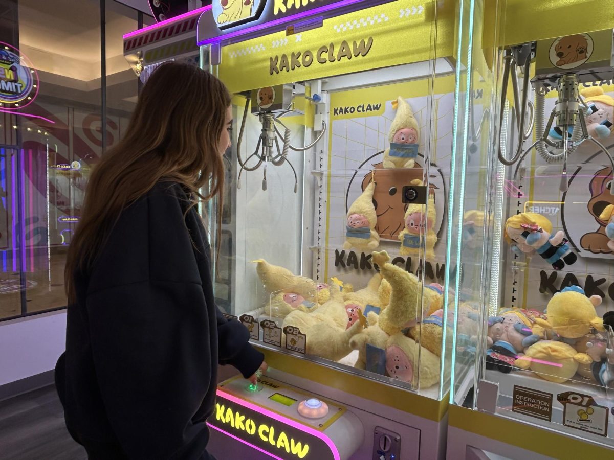 Miri Silverman plays a claw machine at KakoClaw, hoping to win a plushie.