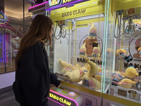 Miri Silverman plays a claw machine at KakoClaw, hoping to win a plushie.