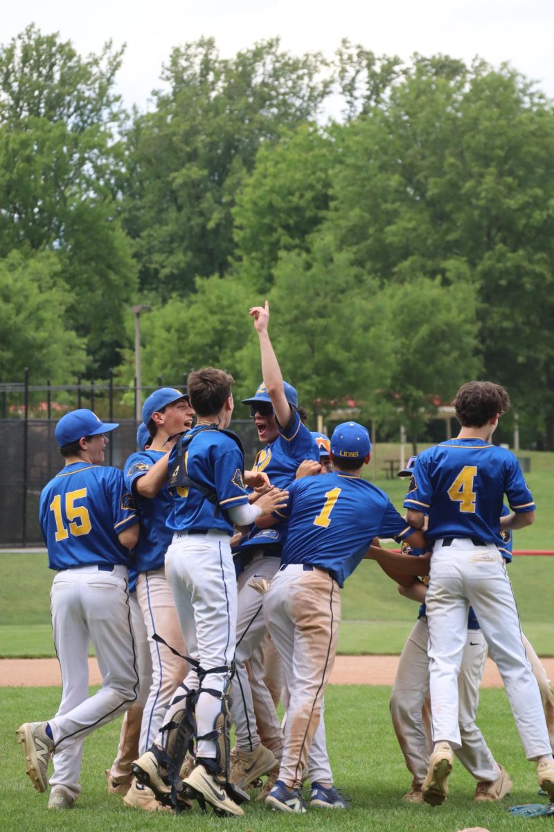 After the final out, players rush toward the pitchers mound to celebrate their championship victory on May 10.