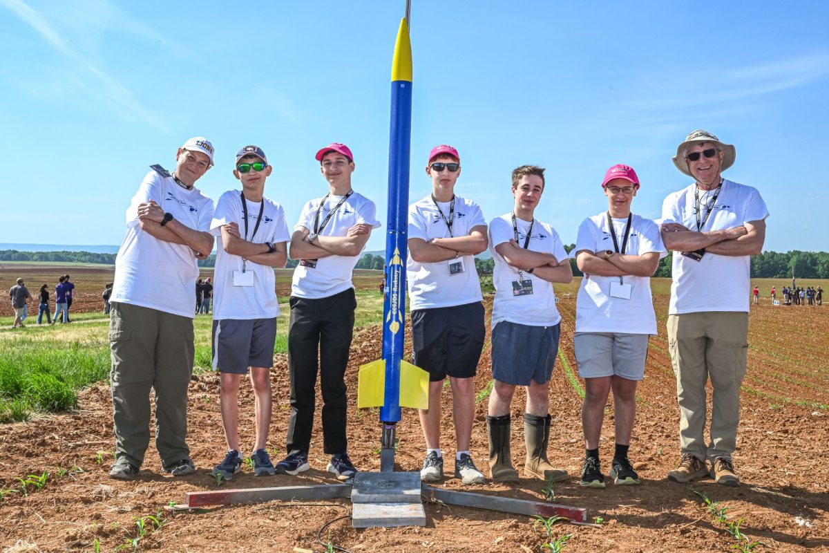 Club adviser Ginger Thornton, students Kyle Berger, Emmanuel Sarantos, Jacob Lavinbuk, Jack Spiegel, Ezra Libbin and mentor Jonathan Rains pose with their rocket.