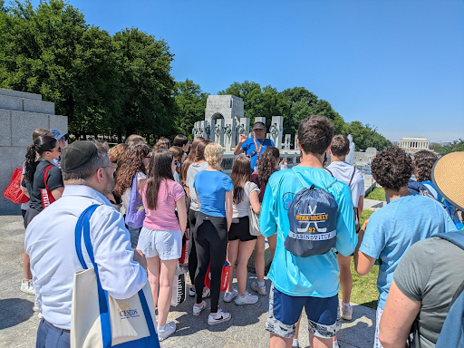 History teacher and former D.C. tour guide Dana Foster gives an intro before the group walks into the World War II Memorial. Students not only learned new facts about the familiar monument, such as that each gold star represents 1,000 American deaths, but also had the opportunity to hear about their teacher’s previous job.