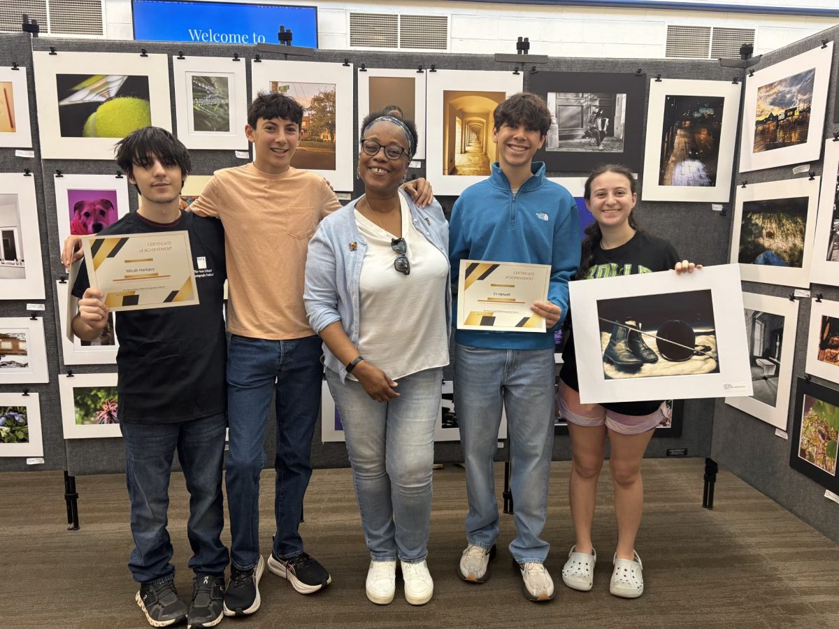 Students pose with their pictures at the NORA photography competition